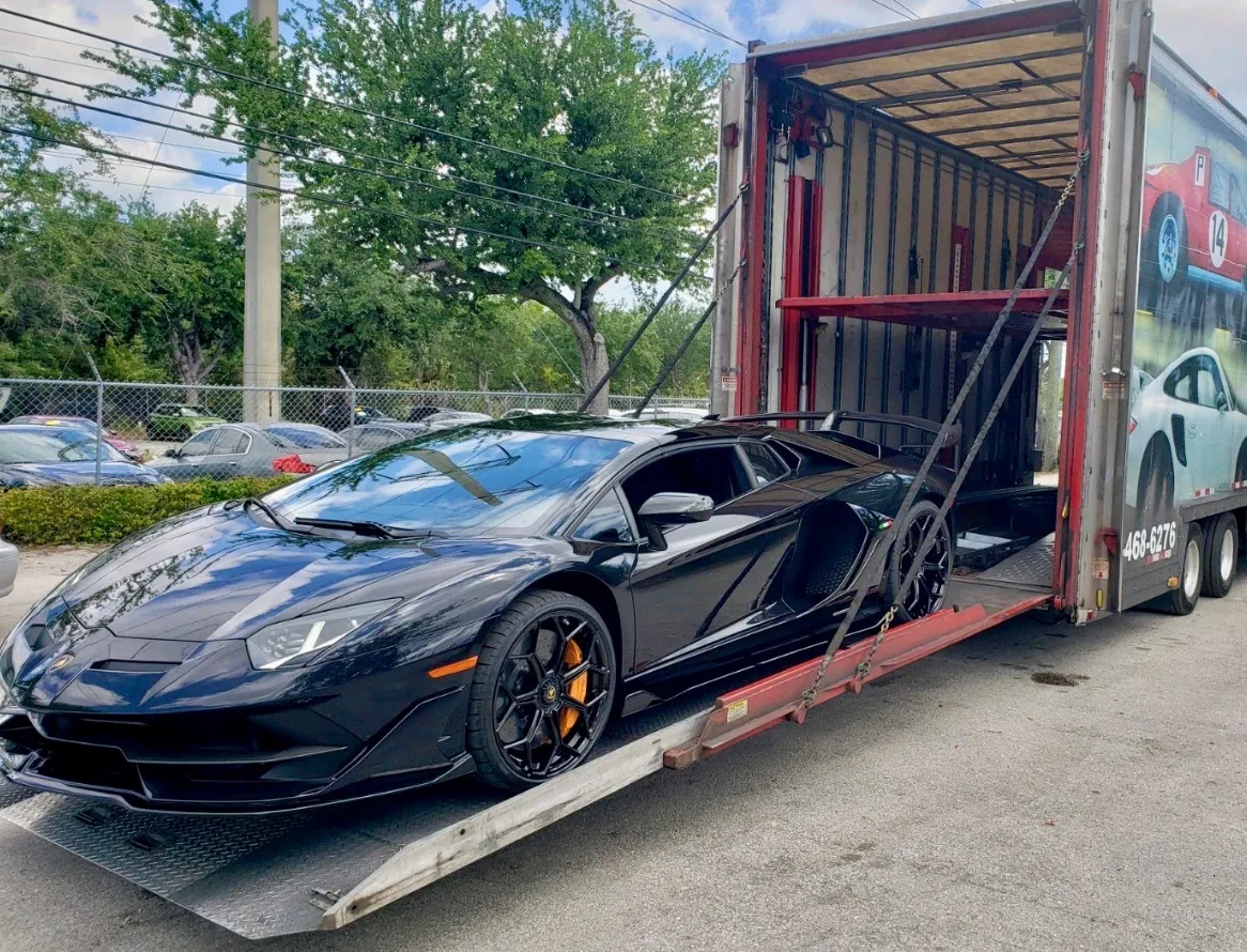Enclosed car transport carrier providing weather protection on Colorado roads