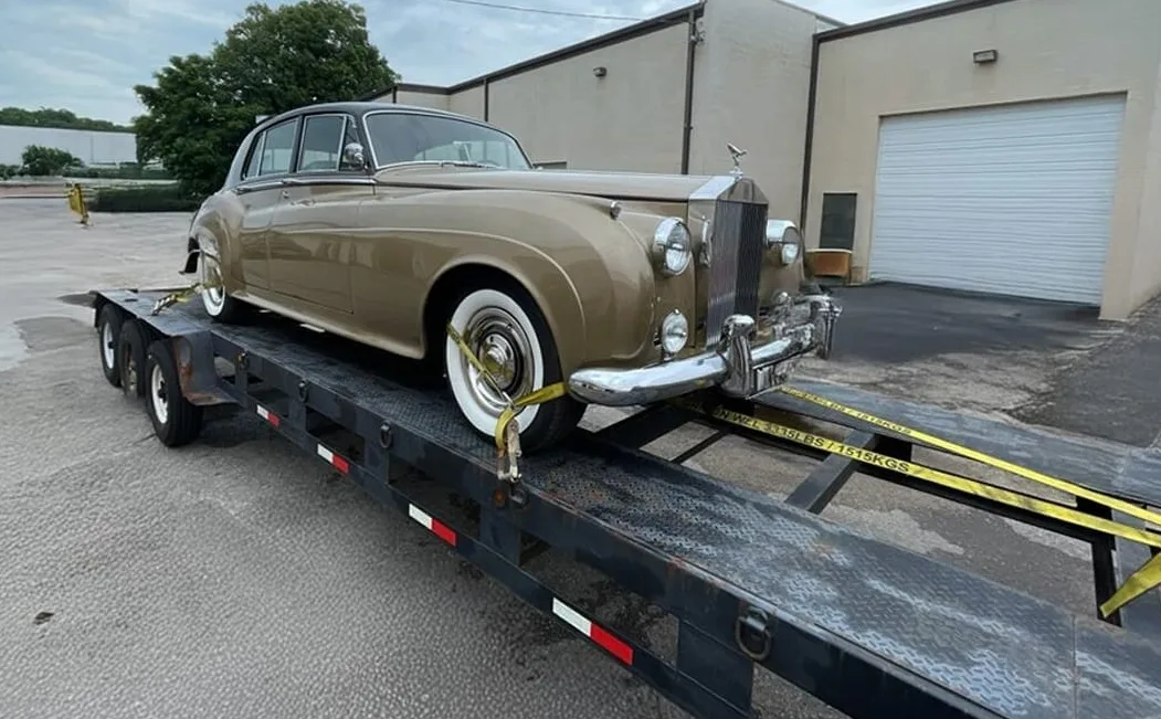 Vehicle owner preparing car for auto transport pickup with condition inspection
