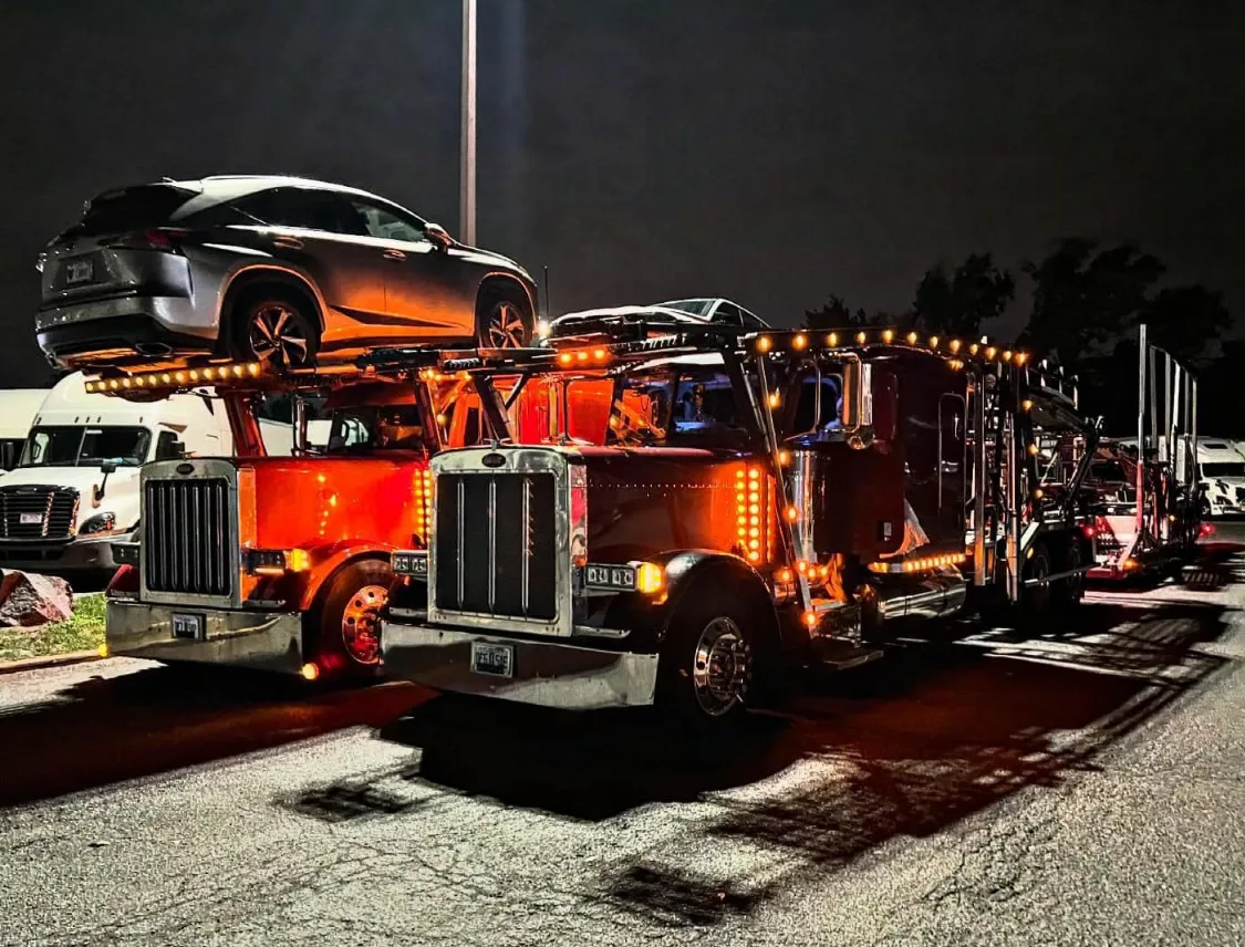 Open car carrier loaded with vehicles on a Colorado highway